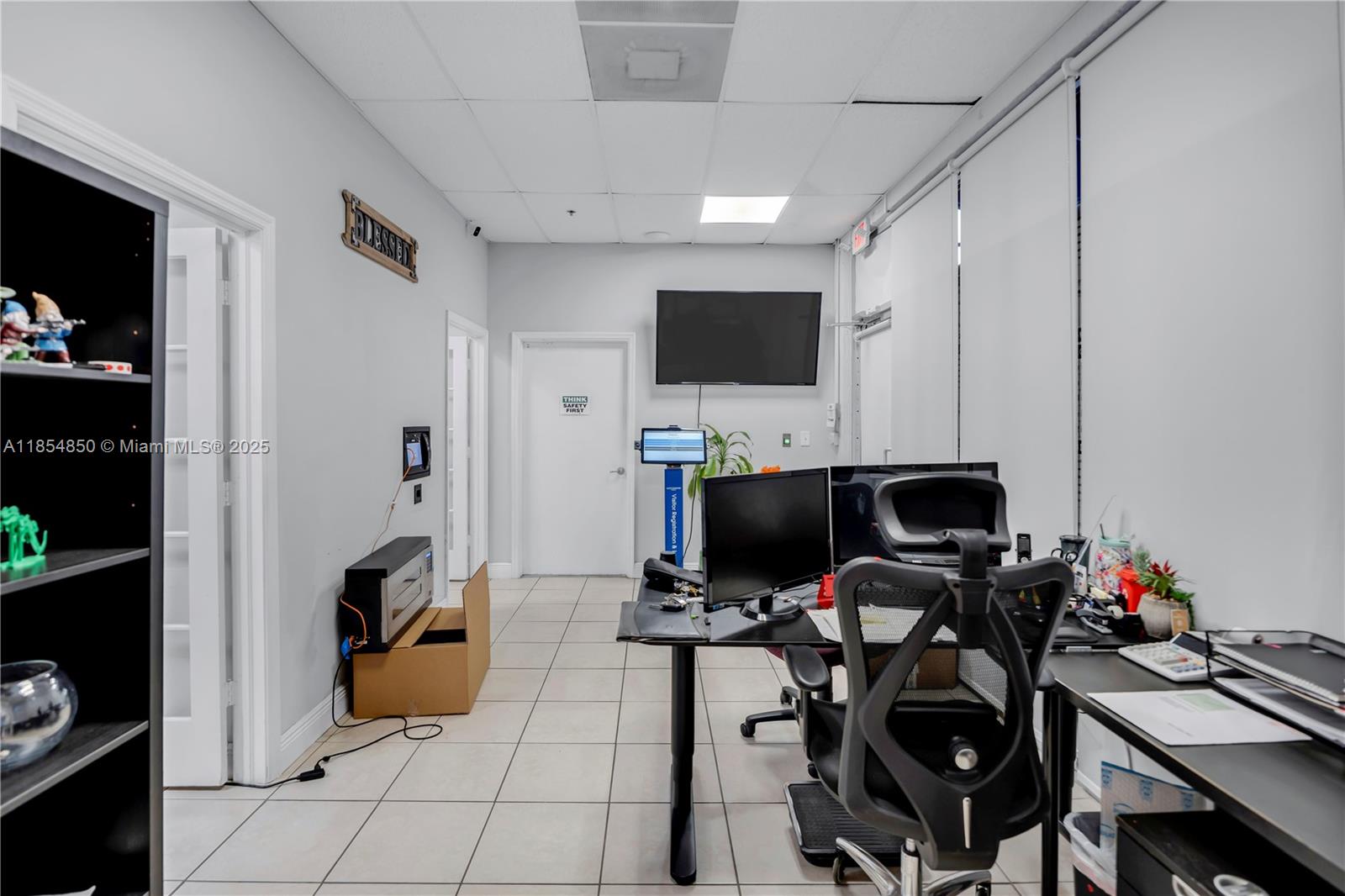 An empty room features light gray walls, beige tile flooring, and a drop ceiling — 4310 SW 73rd Ave # 438890, Miami FL 33155, MIAMI, FL