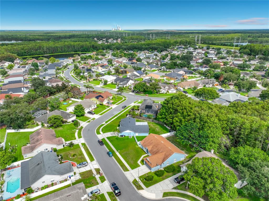 An aerial view shows a suburban neighborhood with houses, green lawns, and winding streets — 3020 HARTLAND COURT, ORLANDO, FL