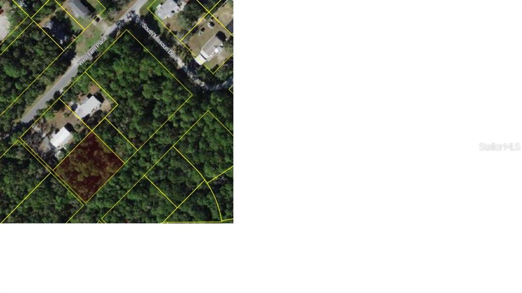 This is an aerial map showing a highlighted vacant lot surrounded by trees and houses — 7941 W OX EYE PLACE, HOMOSASSA, FL