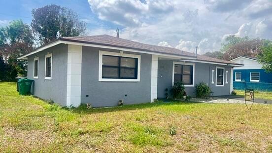 A gray, single-story house with white trim and a brown shingled roof — 113 Hilton Drive, Fort Pierce FL 34946, FORT PIERCE, FL