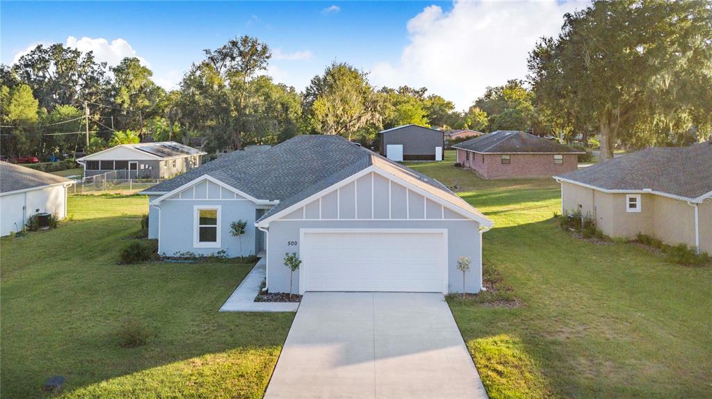 An aerial view of a light blue single-story house with a two-car garage — 500 9TH STREET NE, FORT MEADE, FL