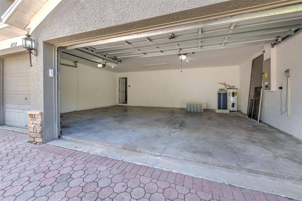 A spacious, covered patio features a concrete floor, ceiling fans, and large screened-in windows — 4752 PATAGONIA PLACE, LAND O LAKES, FL