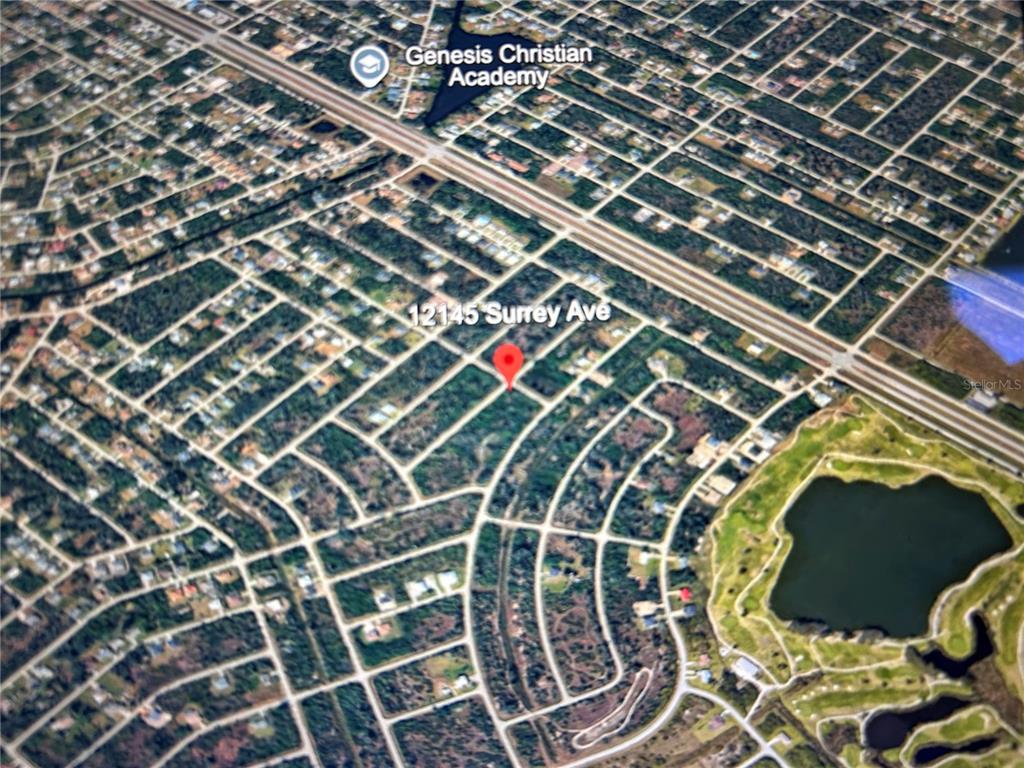 This is an aerial map view showing a residential neighborhood with a highlighted property location — 12145 SURREY AVE, PORT CHARLOTTE, FL