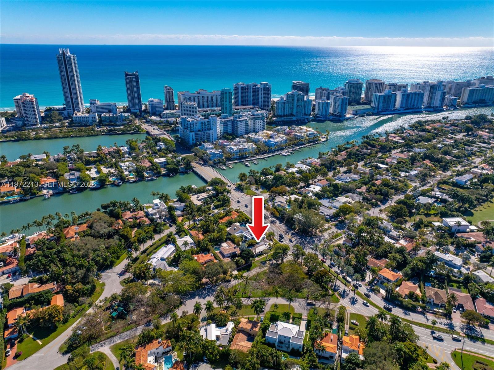 An aerial view shows a residential neighborhood with a red arrow pointing to a house — 6311 La Gorce Dr, Miami Beach FL 33141, MIAMI BEACH, FL
