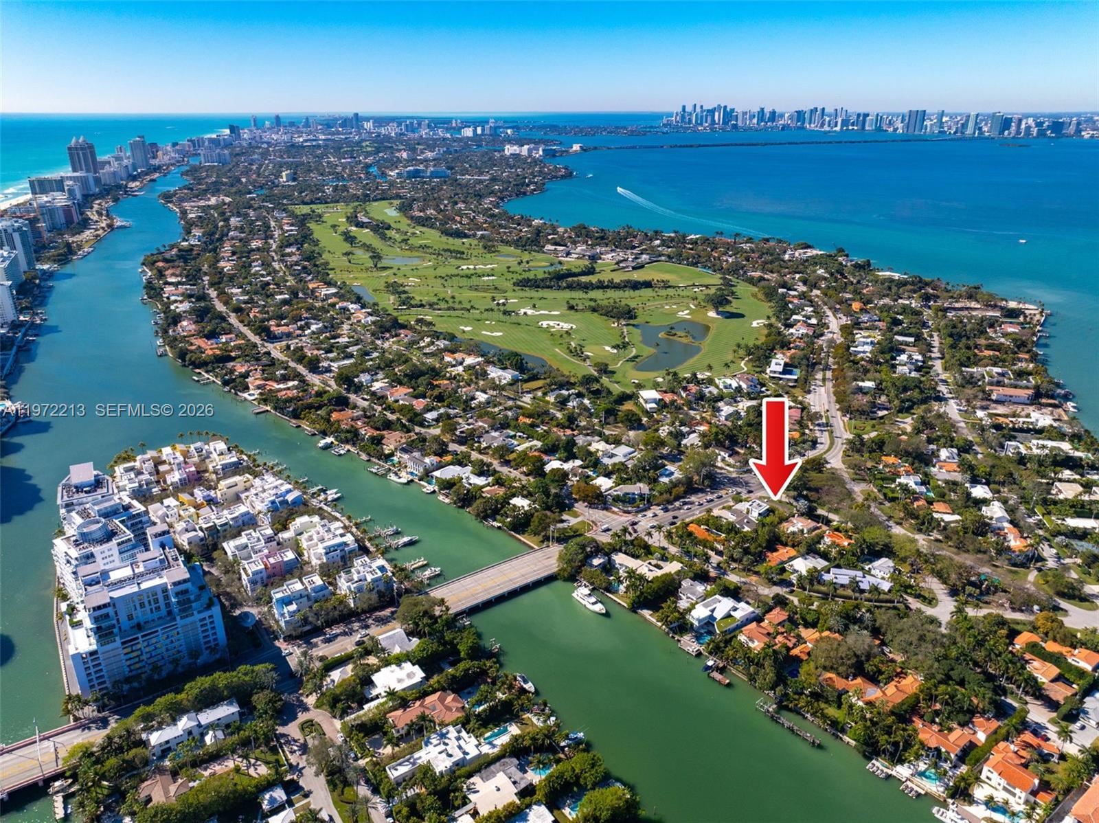 This is an aerial view of a residential neighborhood featuring a golf course and canal — 6311 La Gorce Dr, Miami Beach FL 33141, MIAMI BEACH, FL