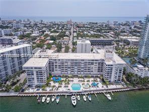 An aerial view of a waterfront apartment complex with a pool and private boat slips — 800 West Ave # 523, Miami Beach FL 33139, MIAMI BEACH, FL