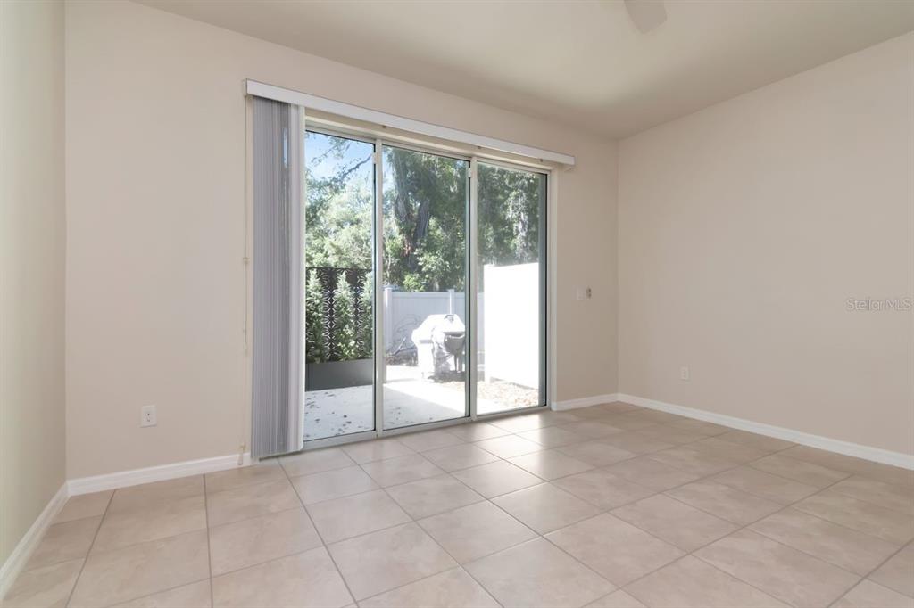 A living room features a beige sectional sofa, a round wooden coffee table, and wood flooring — 5368 SYLVESTER LOOP, TAMPA, FL