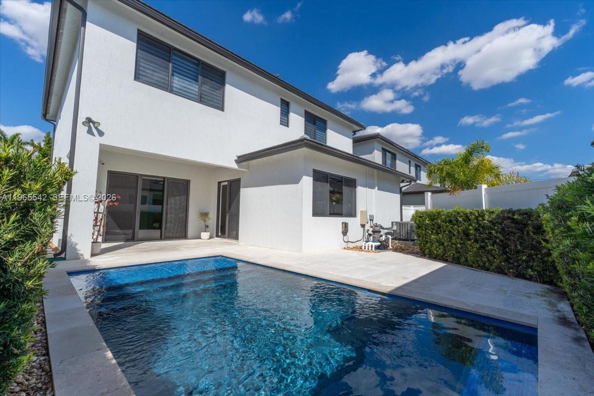 A two-story white house with a swimming pool and a patio in the backyard — 8096 NW 48th Ter, Doral FL 33166, DORAL, FL