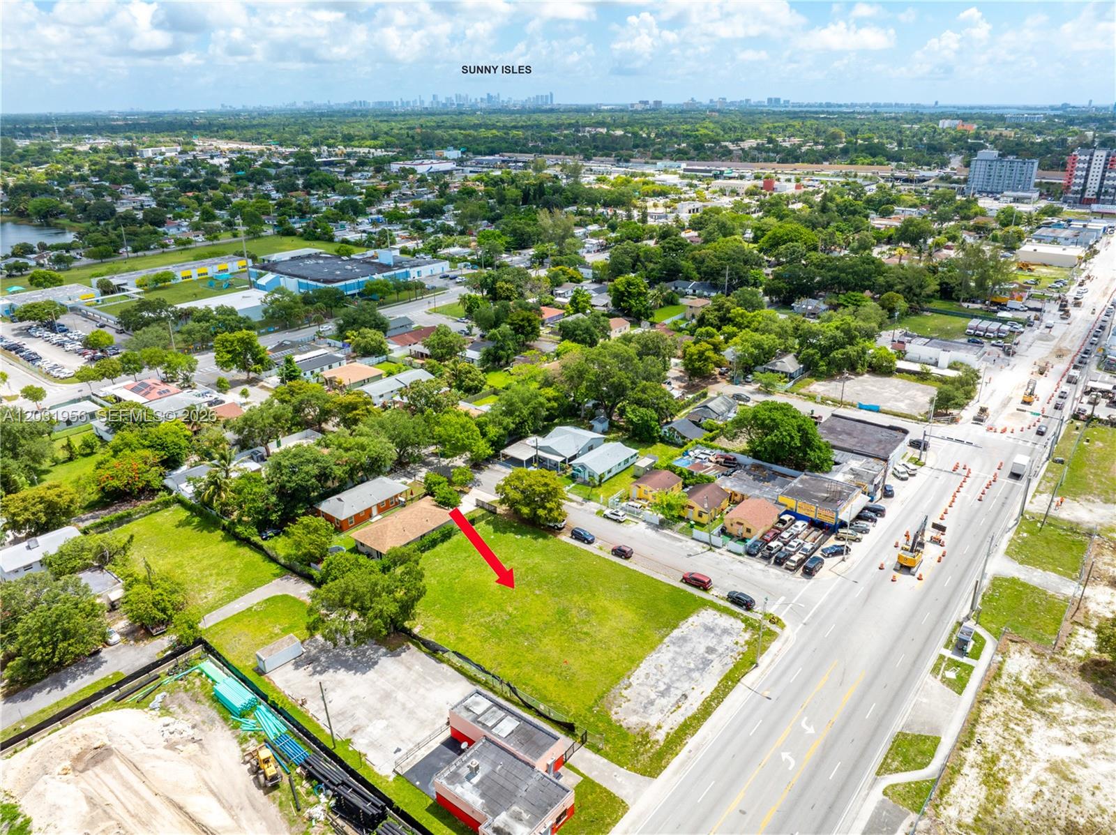 An aerial view shows a vacant, grassy rectangular lot situated next to a busy road — 7920 NW 11th Ave, Miami FL 33150, MIAMI, FL