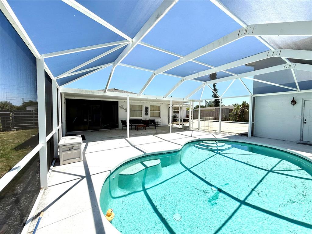 A screened-in patio features a swimming pool with steps and a concrete deck — 1505 MORGAN STREET, NOKOMIS, FL