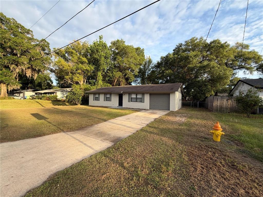A single-story house with a concrete driveway and a fire hydrant in the front yard — 330 DOGWOOD AVENUE, ORANGE CITY, FL
