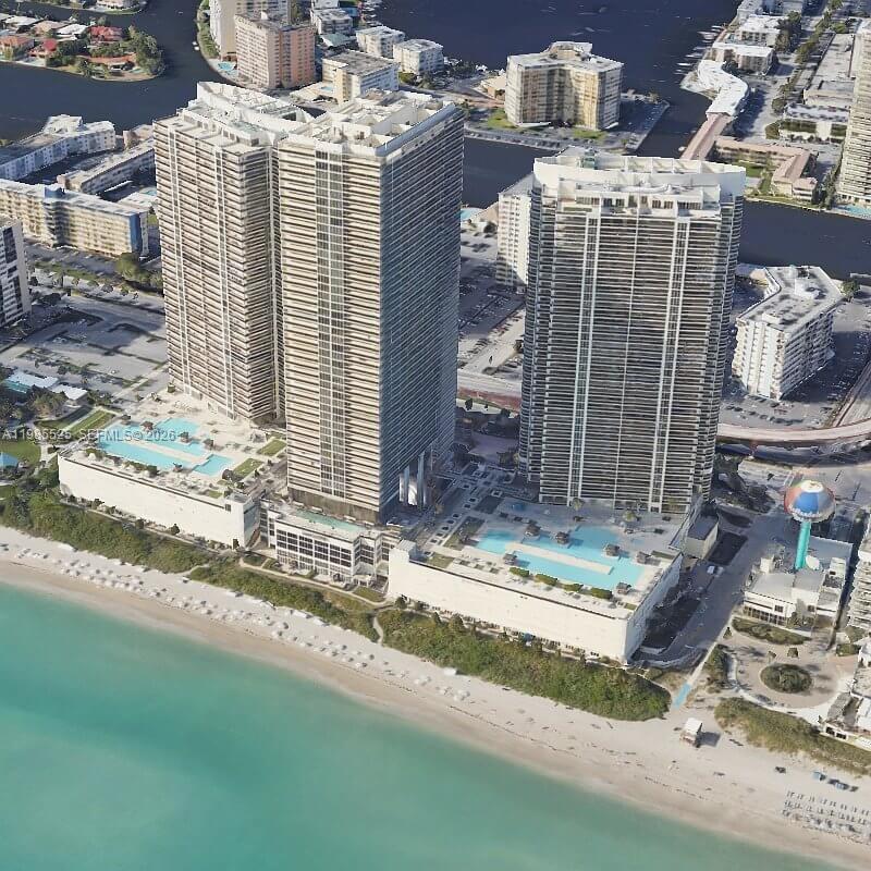 An aerial view of three high-rise residential towers situated directly on a sandy beach — 1800 S Ocean Drive # 3908, Hallandale Beach FL 33009, HALLANDALE BEACH, FL