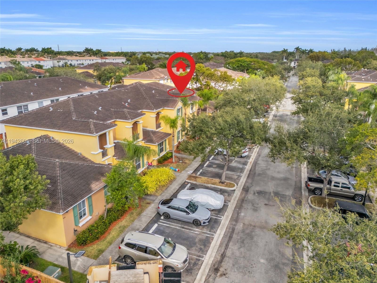 An aerial view shows a yellow multi-story residential building with a red location marker — 950 NE 42nd Pl, Homestead FL 33033, HOMESTEAD, FL
