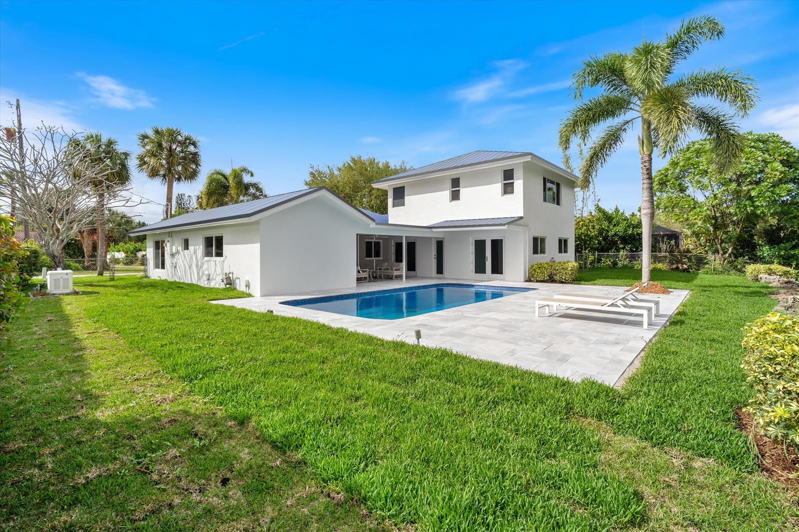 A two-story white house with a swimming pool and patio in a grassy backyard — 440 NW 11th Avenue, Boca Raton FL 33486, BOCA RATON, FL