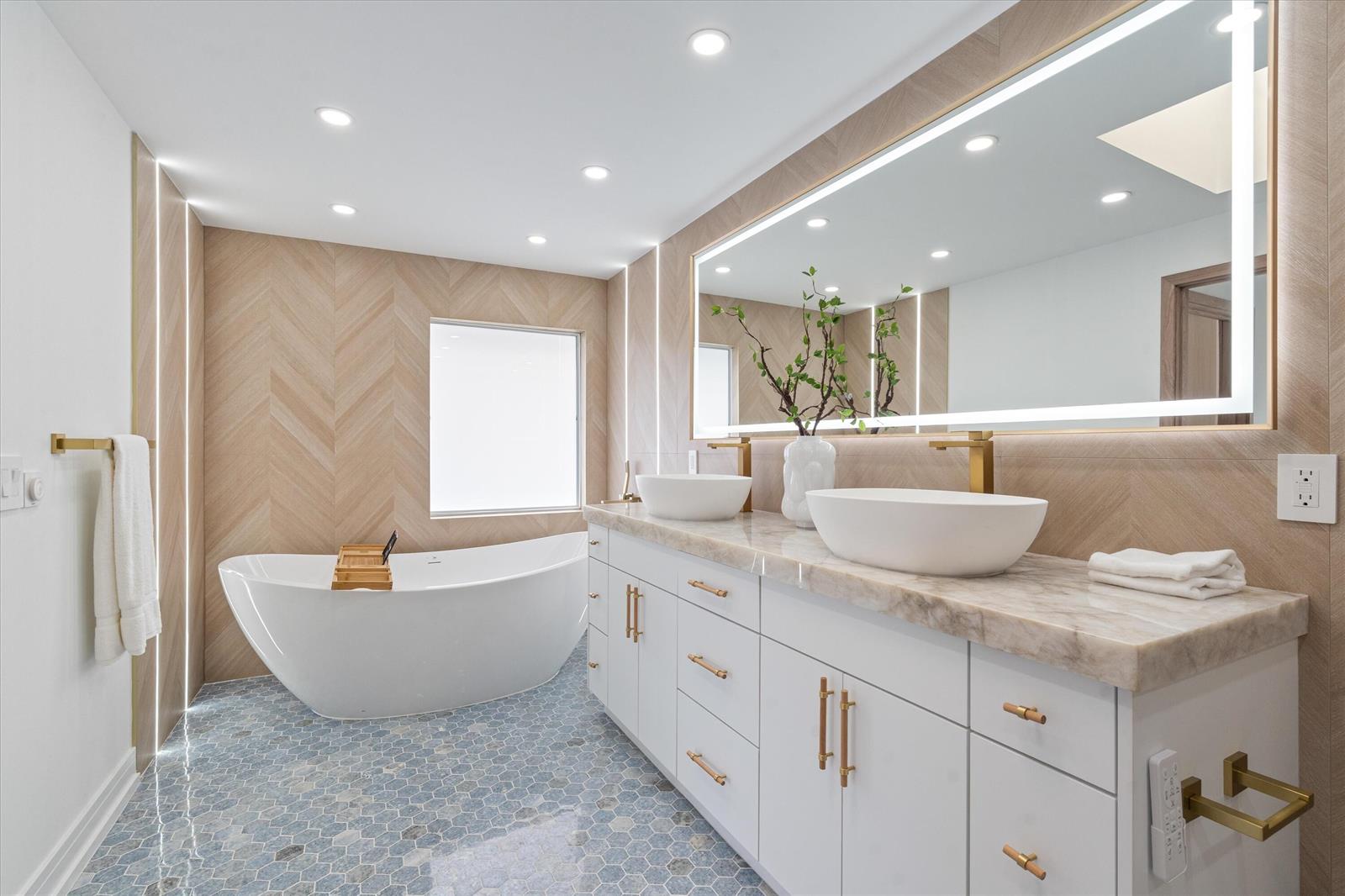 A modern bathroom features a freestanding tub, double vanity, herringbone wood walls, and hexagonal flooring — 440 NW 11th Avenue, Boca Raton FL 33486, BOCA RATON, FL