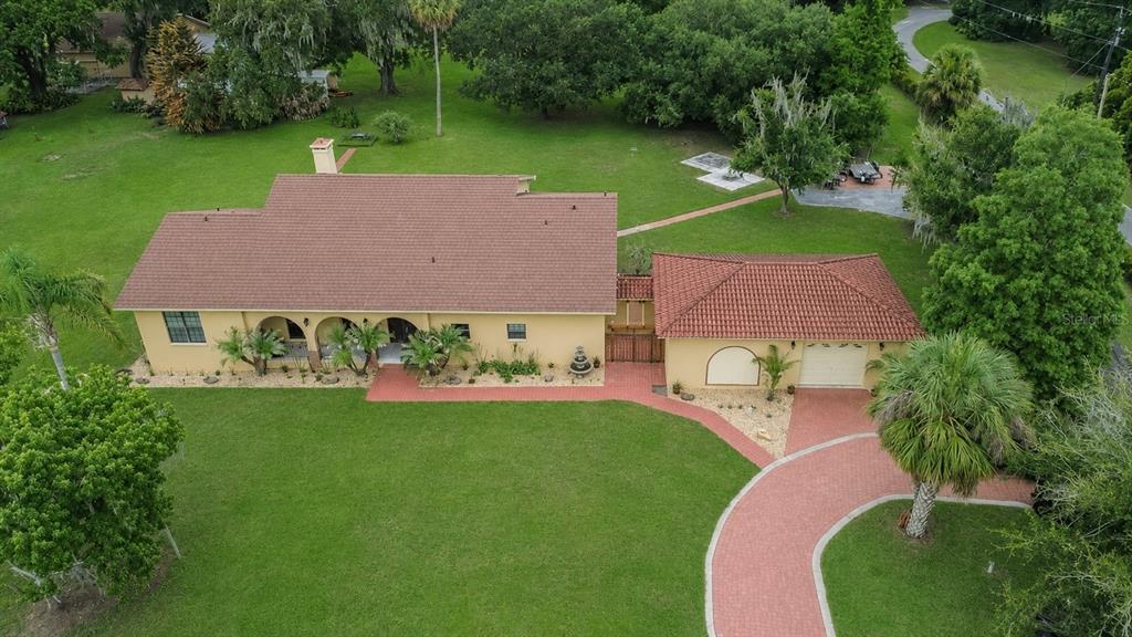 An aerial view of a single-story house with a brown roof and attached garage — 4020 N WILDER ROAD, PLANT CITY, FL