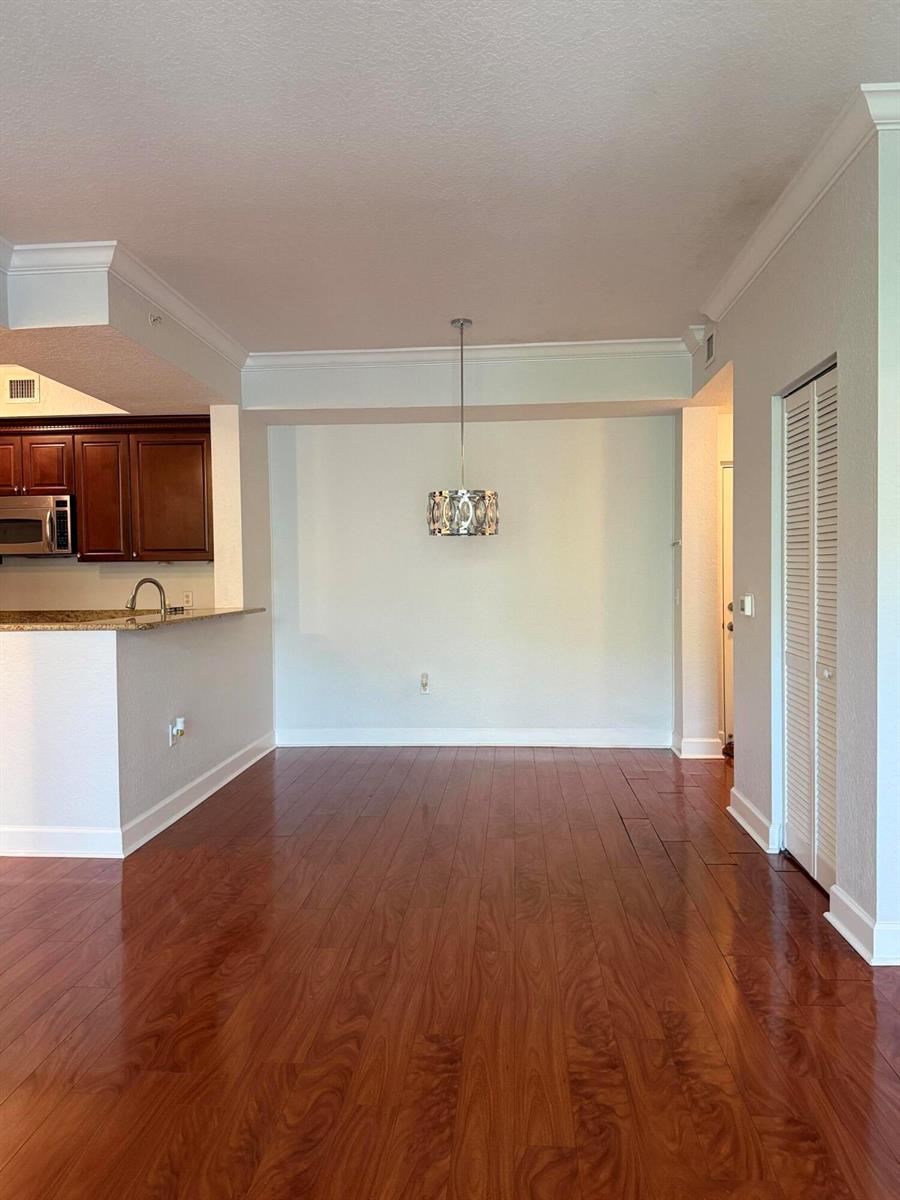 A dining area with hardwood floors, a pendant light, and an adjacent kitchen counter — 3308 Renaissance Way, Boynton Beach FL 33426, BOYNTON BEACH, FL