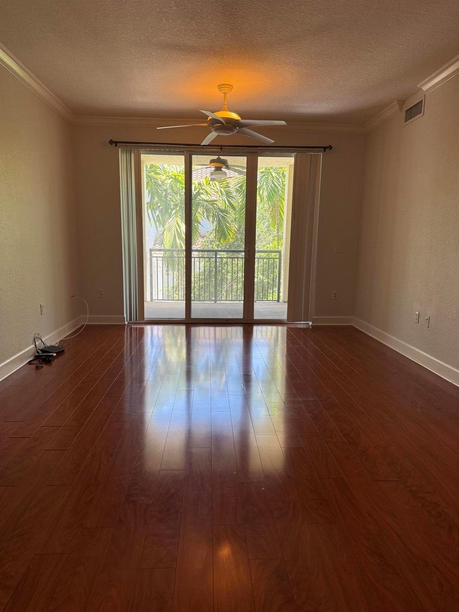 An empty room with hardwood floors, a ceiling fan, and sliding glass doors to a balcony — 3308 Renaissance Way, Boynton Beach FL 33426, BOYNTON BEACH, FL