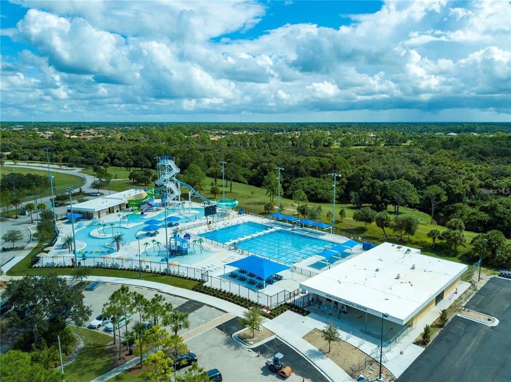 An aerial view of the North Port Aquatic Center featuring pools, slides, and parking — BATOKO STREET, NORTH PORT, FL