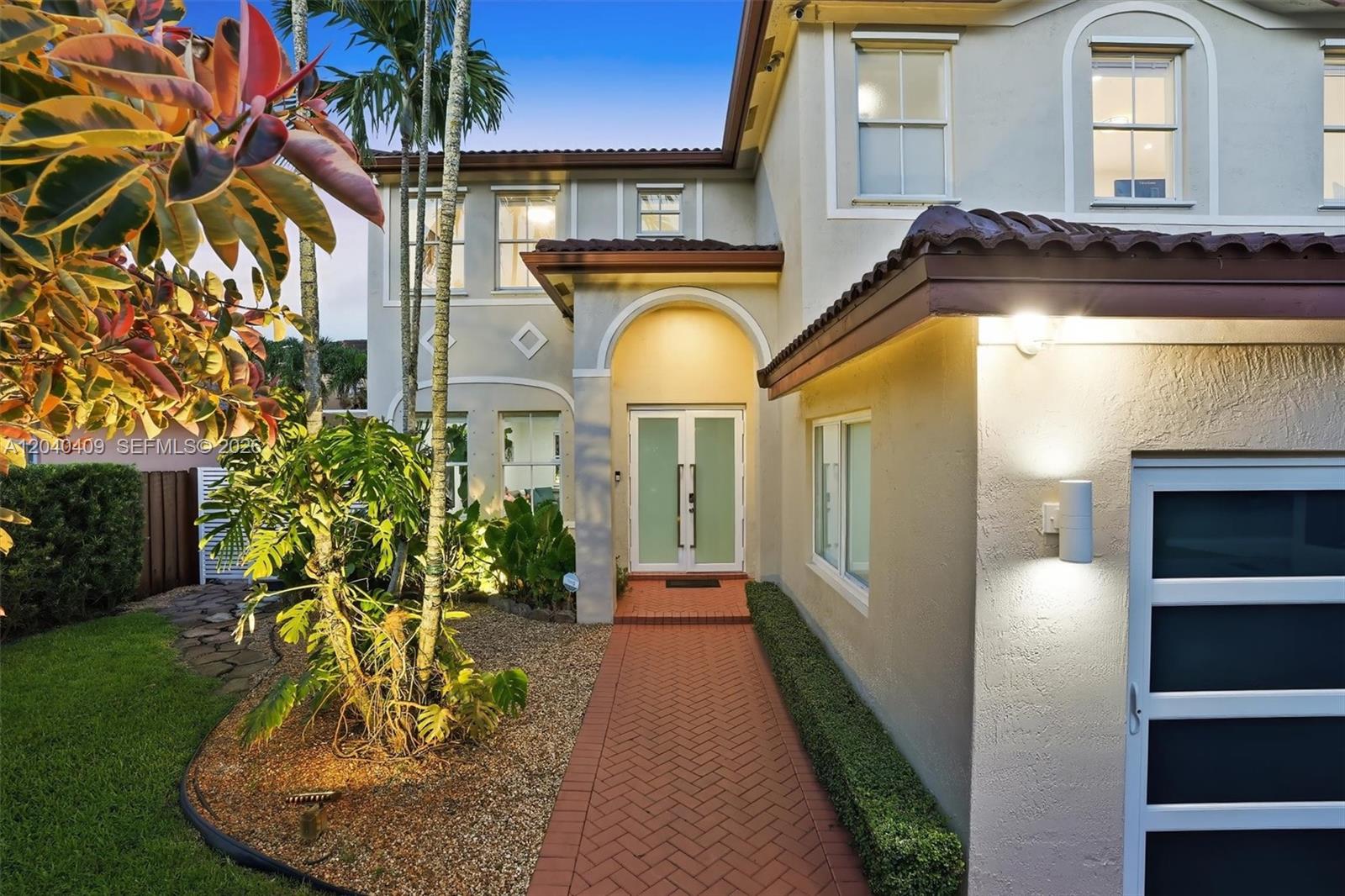 A two-story house features a two-car garage, a brick driveway, and a landscaped front yard — 2517 SW 148th Ct, Miami FL 33185, MIAMI, FL