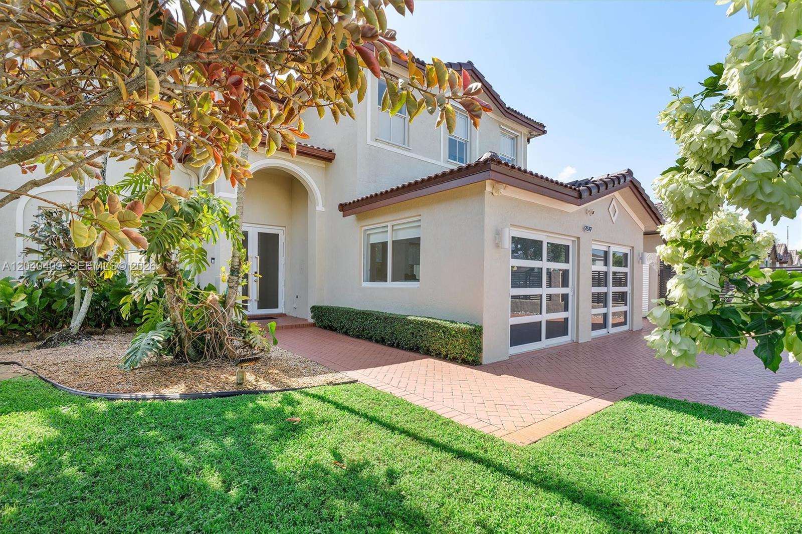 A two-story house with a tiled roof, a brick driveway, and a two-car garage — 2517 SW 148th Ct, Miami FL 33185, MIAMI, FL