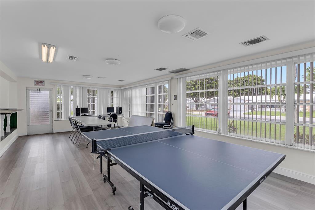 A recreation room features a ping pong table, computer workstations, and large windows with blinds — 2910 E Golf Boulevard, Pompano Beach FL 33064, POMPANO BEACH, FL