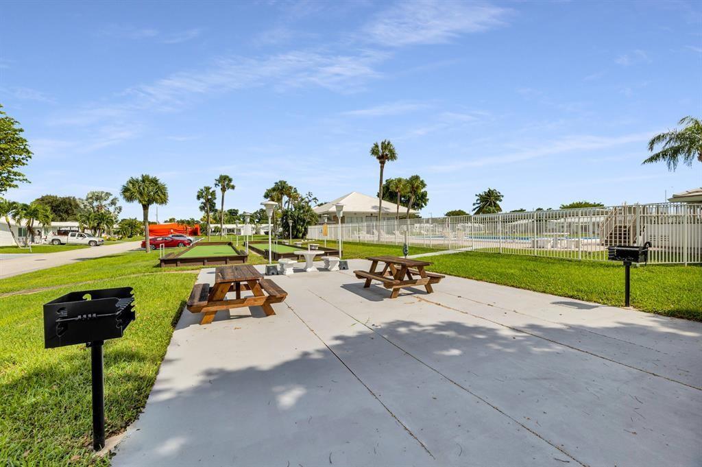 An outdoor patio area features two picnic tables, two grills, and two bocce ball courts — 2910 E Golf Boulevard, Pompano Beach FL 33064, POMPANO BEACH, FL