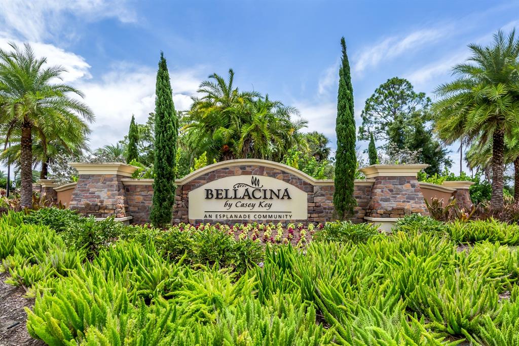 A stone monument sign for Bellacina by Casey Key stands amidst palm trees and landscaping — 5853 SEMOLINO STREET, NOKOMIS, FL
