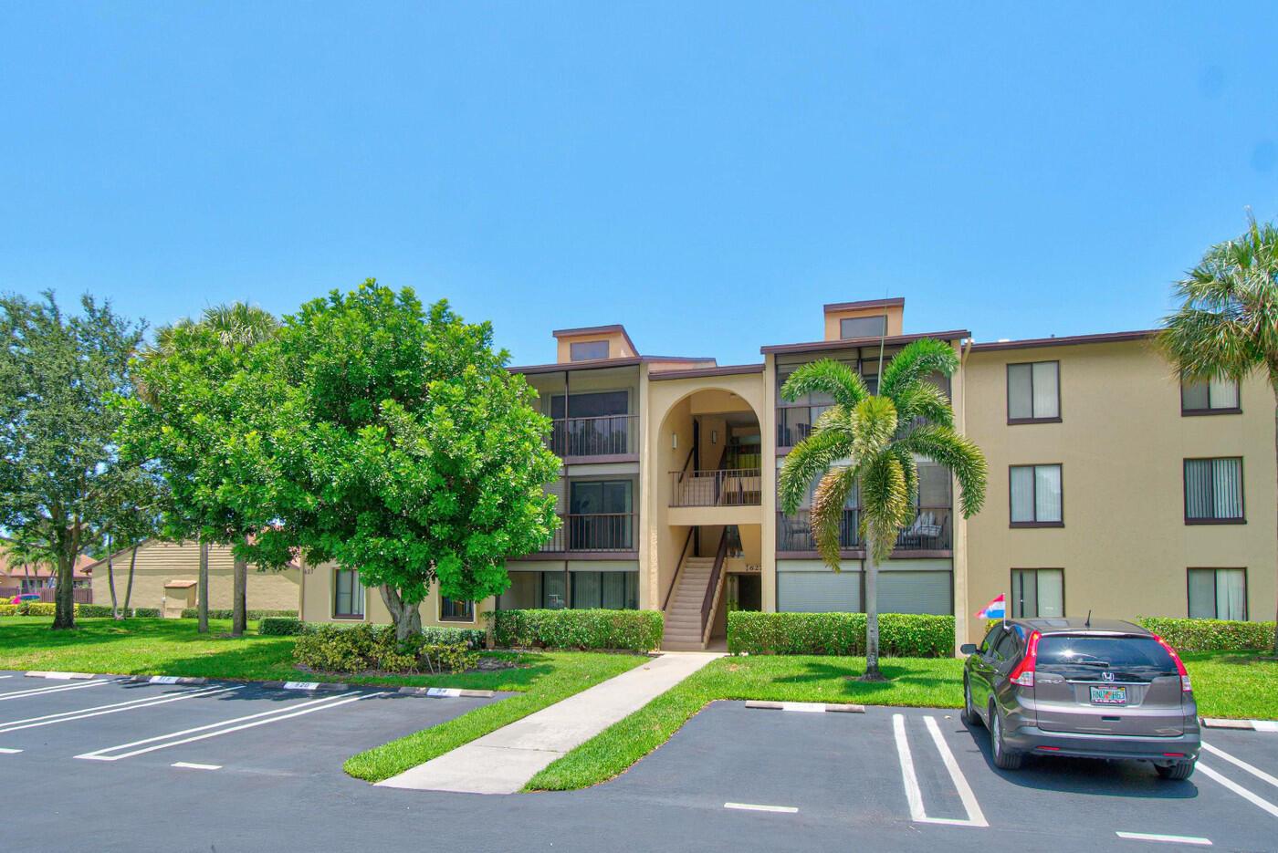 A three-story apartment building with a parking lot and palm trees in front — 627 Sea Pine Way # A3, FL 33415, FL