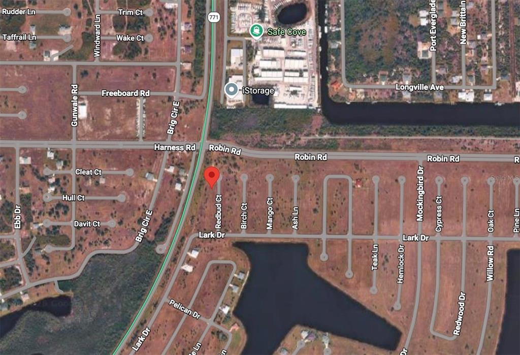 This is an aerial map view of a residential neighborhood with streets and a lake — 13 REDBUD COURT, PLACIDA, FL