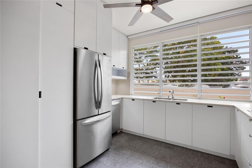 A kitchen with white cabinets, stainless steel appliances, a sink, and louvered windows — K1 AVE. LUIS VIGOREAUX UNIT k, GUAYNABO, PR