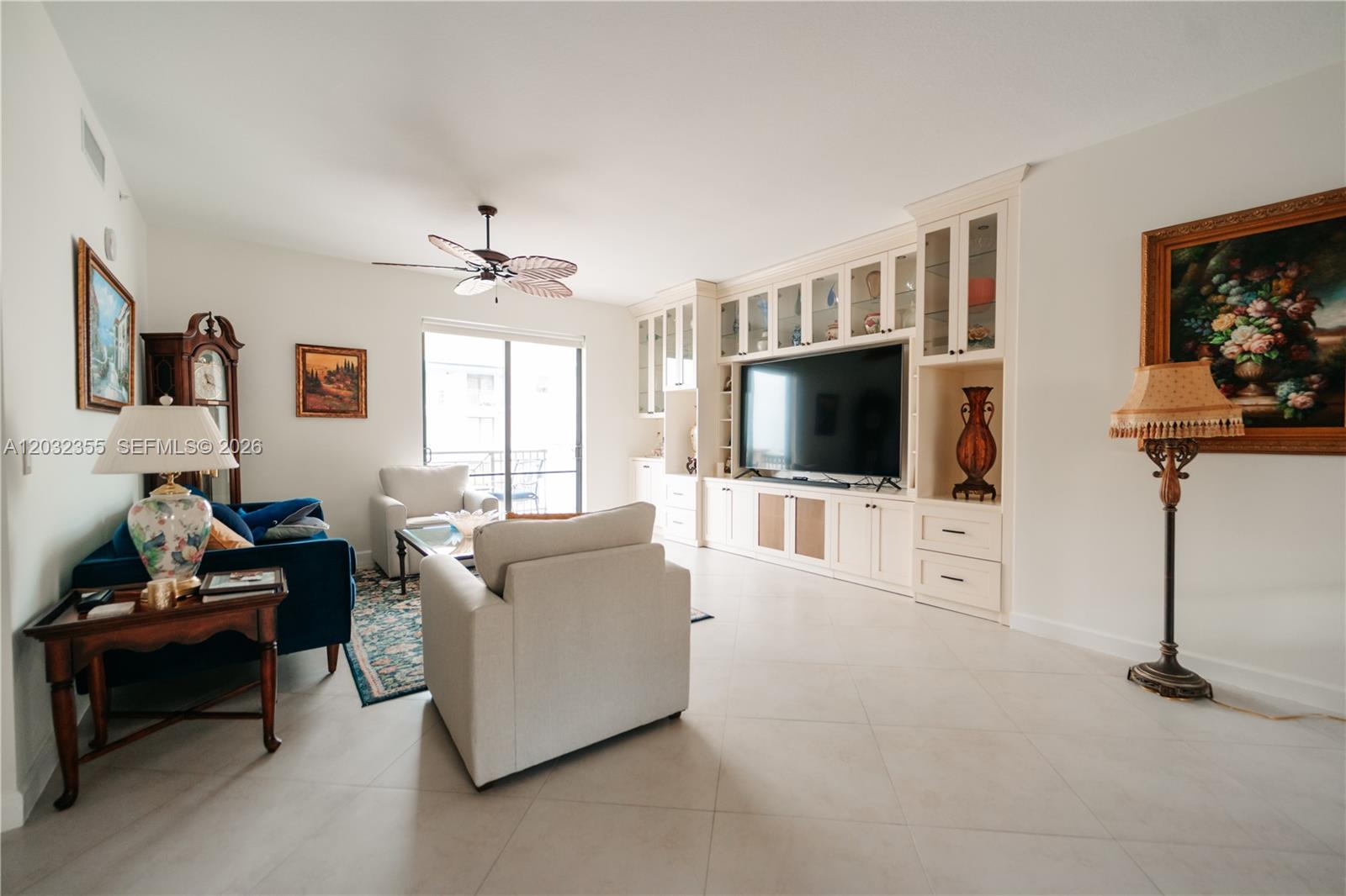 A dining area with a wooden table and chairs sits adjacent to a kitchen island — 8390 SW 72nd Ave # 707, Miami FL 33143, MIAMI, FL
