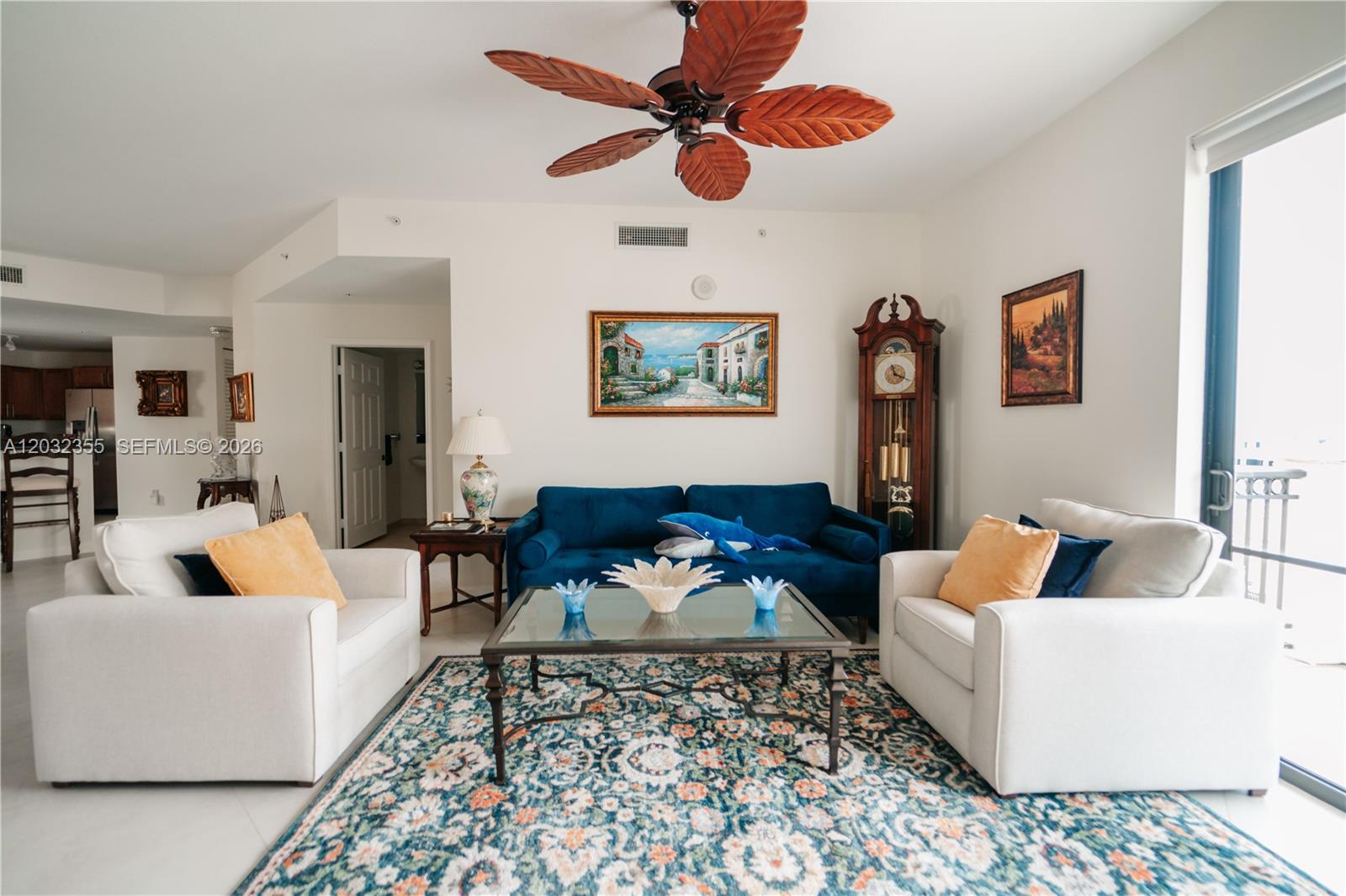 A living room features a large built-in entertainment center, tile floors, and a ceiling fan — 8390 SW 72nd Ave # 707, Miami FL 33143, MIAMI, FL