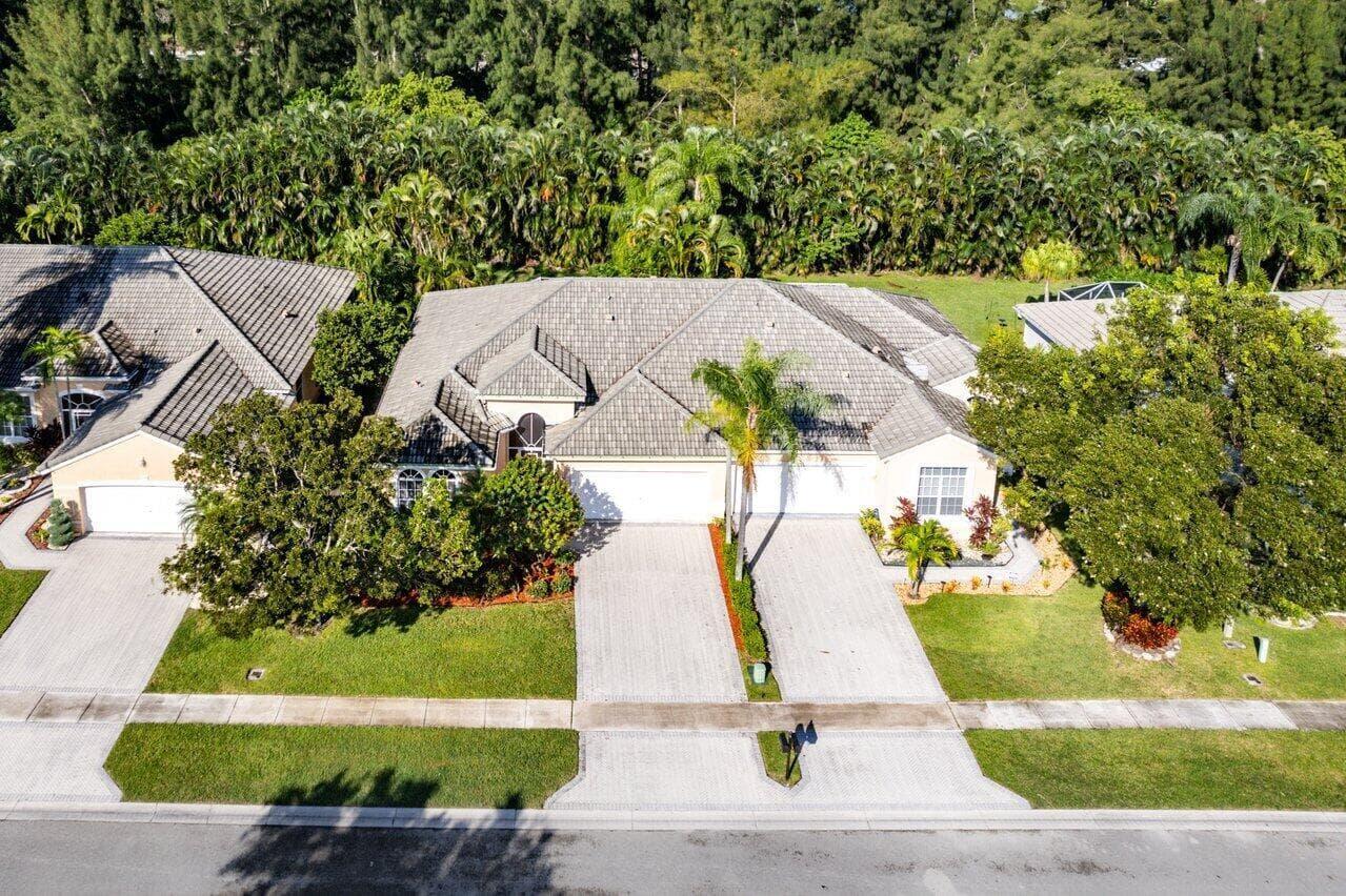An aerial view of a suburban house with a gray tiled roof and paved driveways — 7940 Rockford Road, Boynton Beach FL 33472, BOYNTON BEACH, FL
