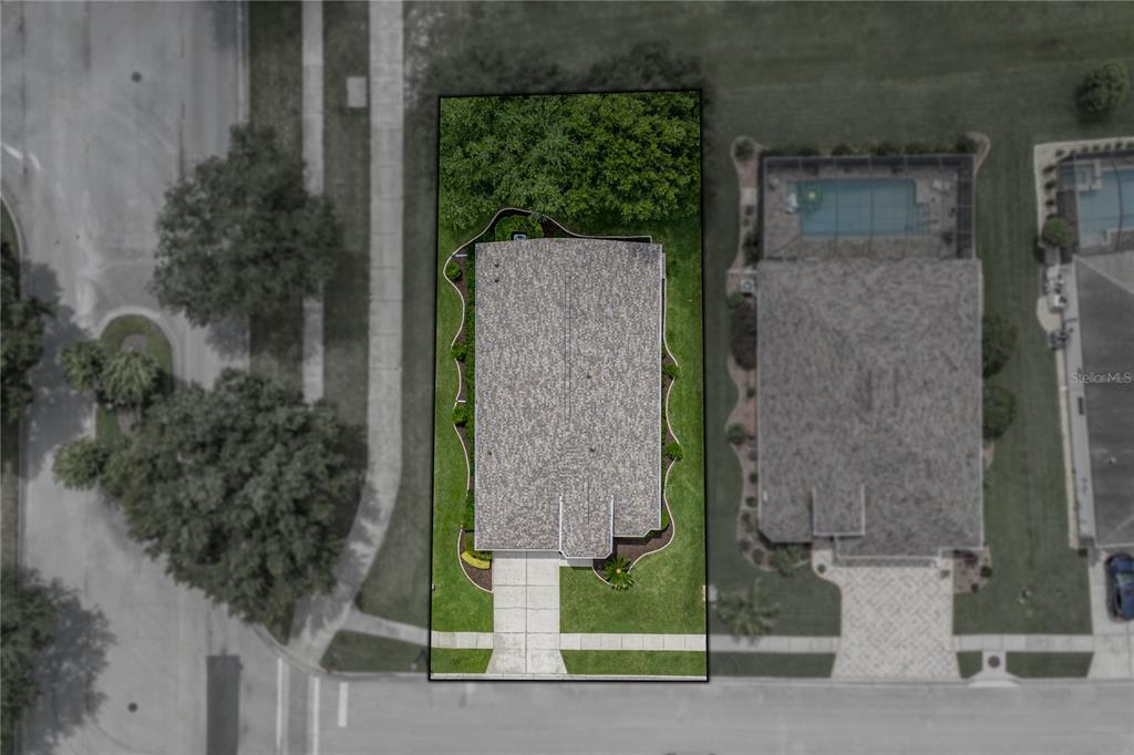 An aerial view shows a single-family home with a gray roof on a rectangular lot — 5064 GEVALIA DRIVE, BROOKSVILLE, FL