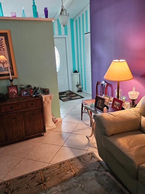 A living room features a wooden cabinet, a lamp on a side table, and tiled floors — 6551 Winding Brooke Way, Delray Beach FL 33484, DELRAY BEACH, FL