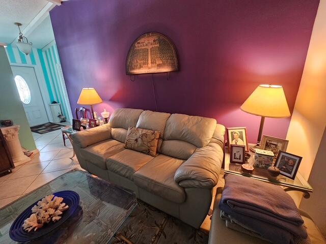 A living room features a beige leather sofa against a purple wall with two lamps — 6551 Winding Brooke Way, Delray Beach FL 33484, DELRAY BEACH, FL