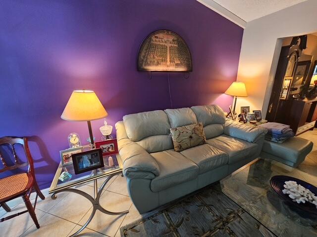 A living room features a purple wall, a light-colored sofa, and a glass-topped side table — 6551 Winding Brooke Way, Delray Beach FL 33484, DELRAY BEACH, FL