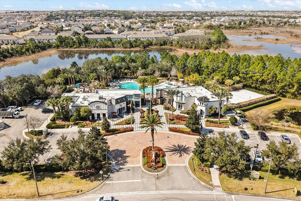 An aerial view of a community clubhouse featuring a pool, parking lot, and surrounding landscape — 337 CAPTIVA DRIVE, DAVENPORT, FL