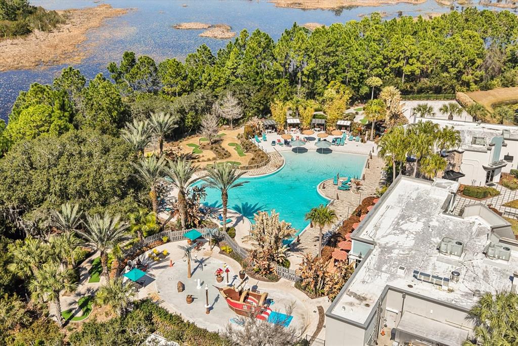 An aerial view shows a swimming pool, a children's splash pad, and a miniature golf course — 337 CAPTIVA DRIVE, DAVENPORT, FL