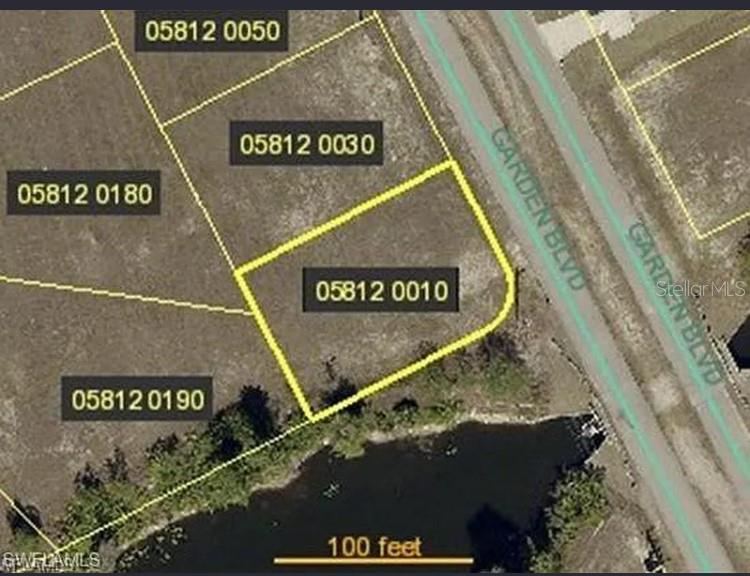 This is an aerial map view of a vacant residential lot bordering a small pond — 4402 GARDEN BOULEVARD, CAPE CORAL, FL