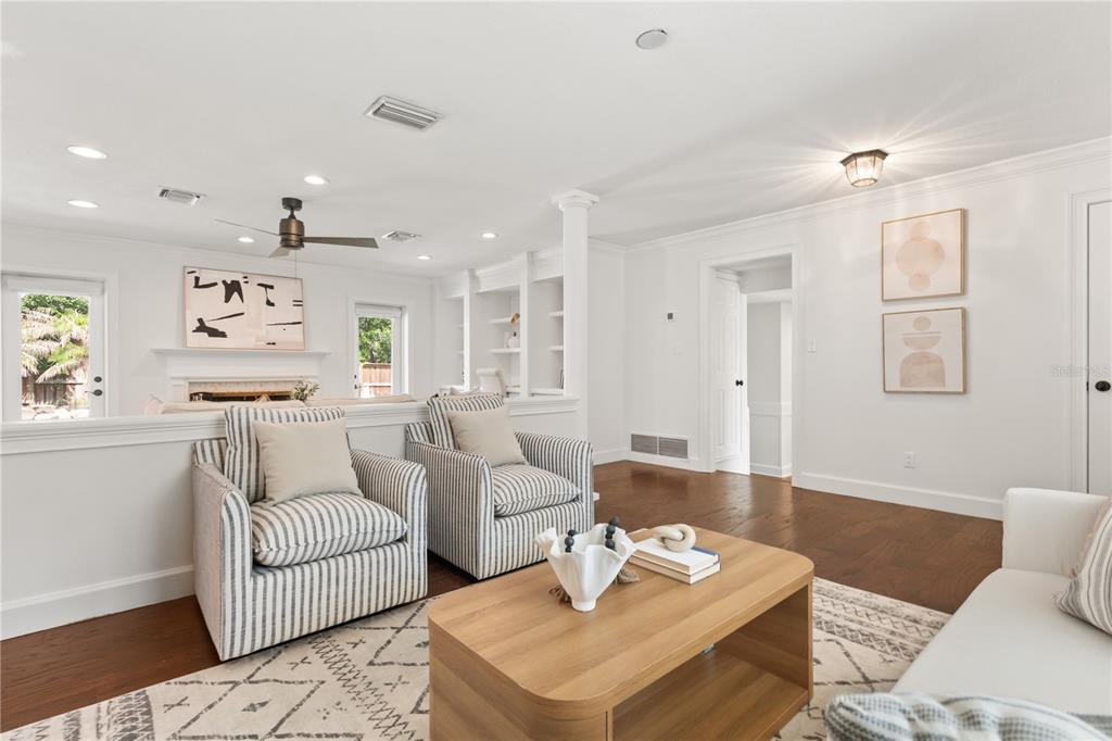 A living room features two striped armchairs, a wooden coffee table, and built-in shelving — 703 NICOMA TRAIL, MAITLAND, FL