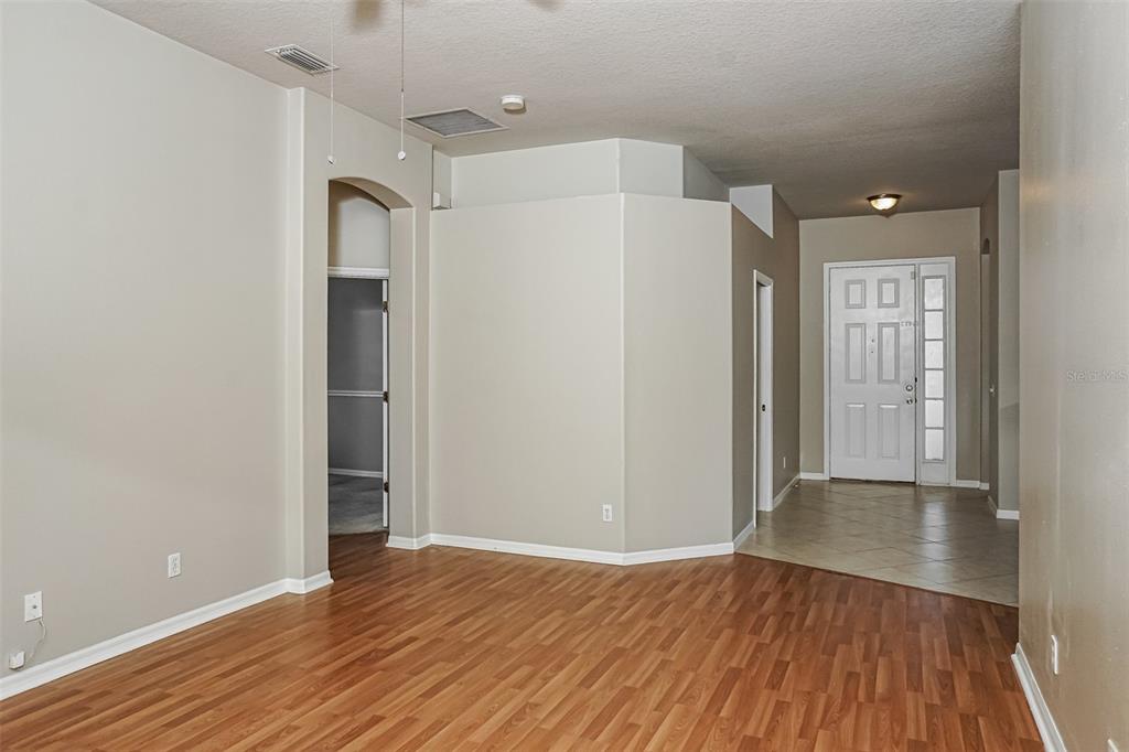 An interior view shows a living area with wood-look flooring and a tiled entryway — 1840 SUMMER WALK CIRCLE, SARASOTA, FL