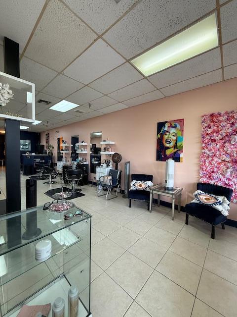 A hair salon interior features light pink walls, tile flooring, and a floral accent wall — 4609 Lake Worth Road # 4609, FL 33463, FL