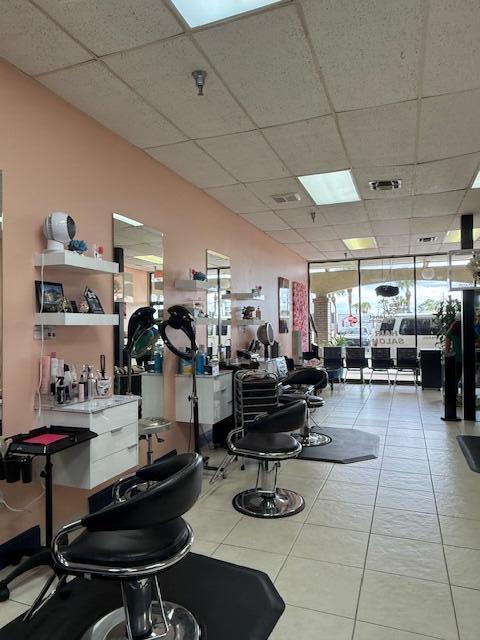 A hair salon interior features multiple styling stations with mirrors, chairs, and white storage cabinets — 4609 Lake Worth Road # 4609, FL 33463, FL