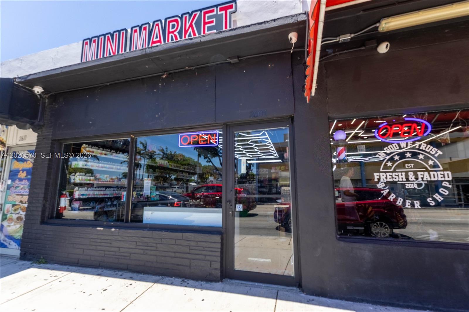 The exterior of a commercial building features a mini market and a barber shop — 2607 Flagler St, Miami FL 33135, MIAMI, FL