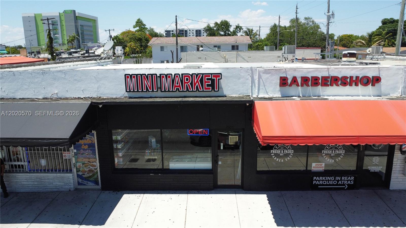 An exterior view of a commercial building featuring a mini market and a barbershop — 2607 Flagler St, Miami FL 33135, MIAMI, FL
