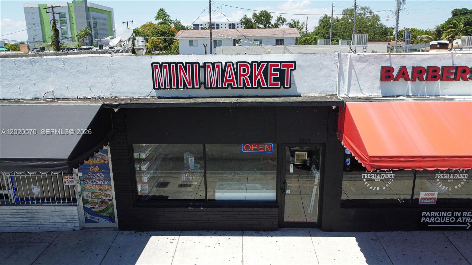 An exterior view of a storefront with a Mini Market sign and adjacent barber shop — 2607 Flagler St, Miami FL 33135, MIAMI, FL