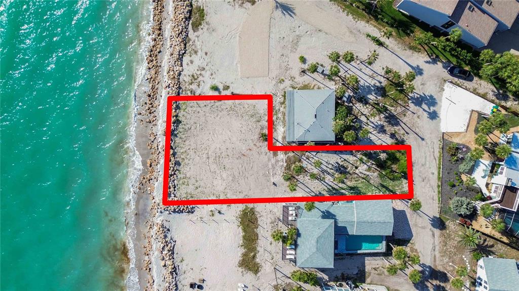 An aerial view shows a vacant, L-shaped waterfront lot outlined in red next to houses — 4076 N BEACH ROAD UNIT CTG6, ENGLEWOOD, FL