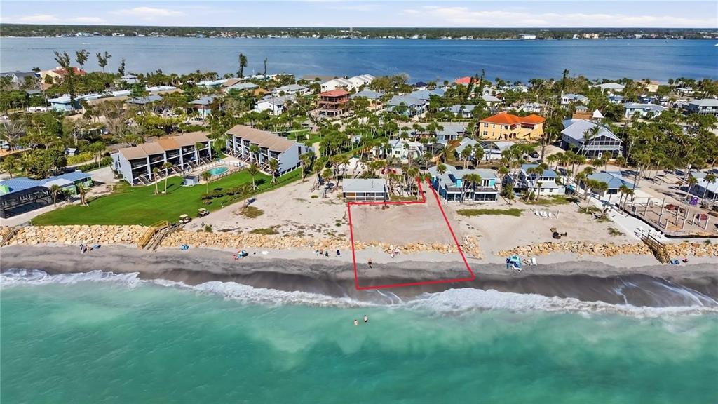An aerial view shows a beachfront lot outlined in red next to a small house — 4076 N BEACH ROAD UNIT CTG6, ENGLEWOOD, FL